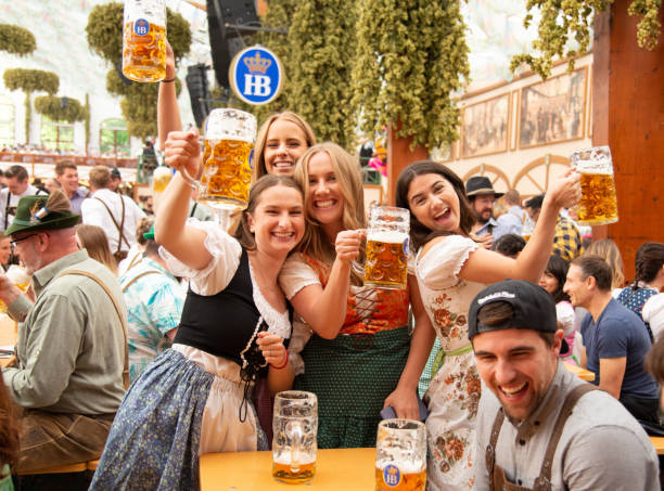 A lifestyle image of a group wearing MrLederhosen’s waistcoats and jackets at an Oktoberfest table